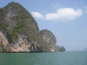 Sea-eroded limestone at the base creates caves